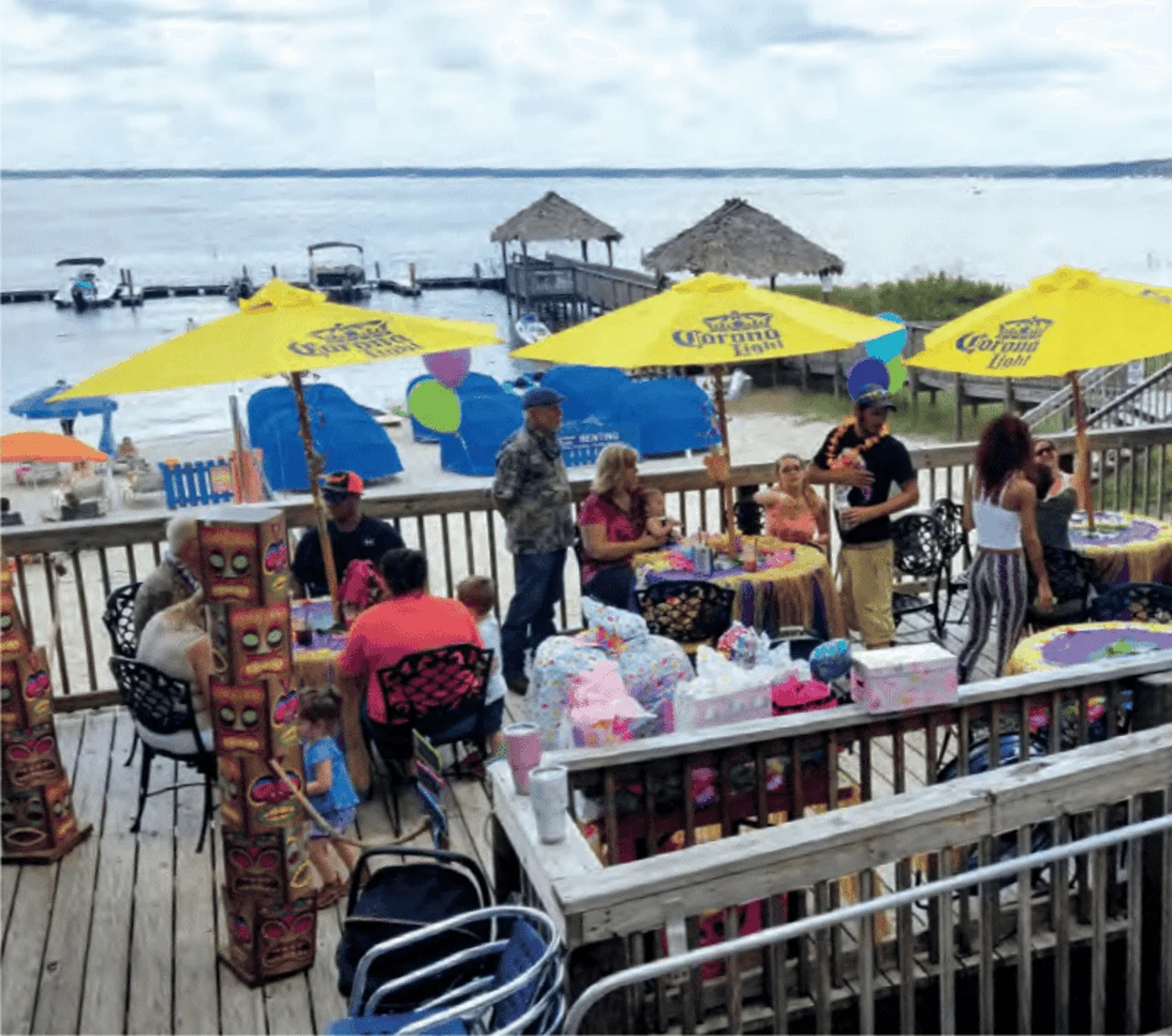 Outdoor dining area by the water with colorful umbrellas