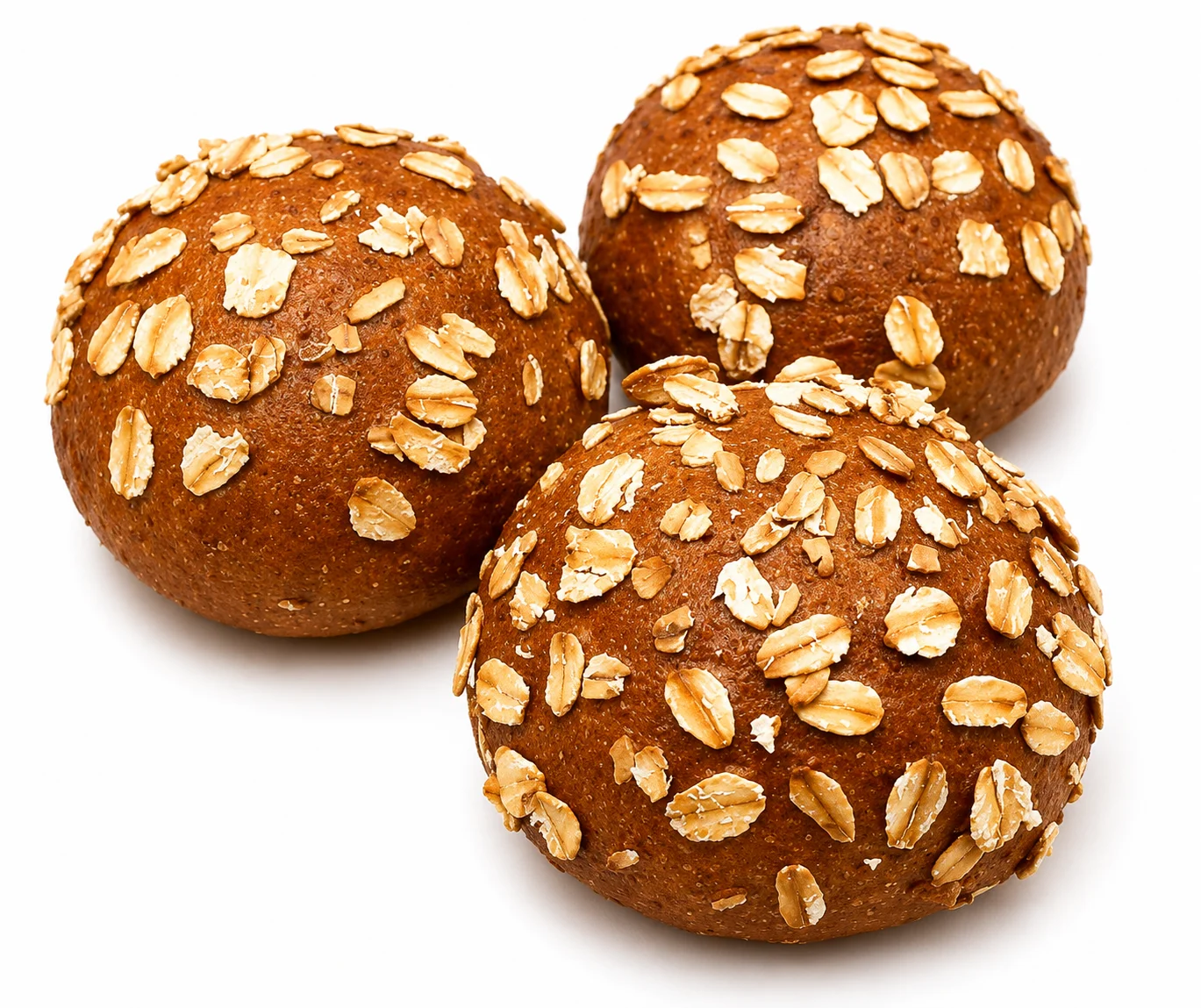 Three round chocolate oat balls topped with rolled oats.