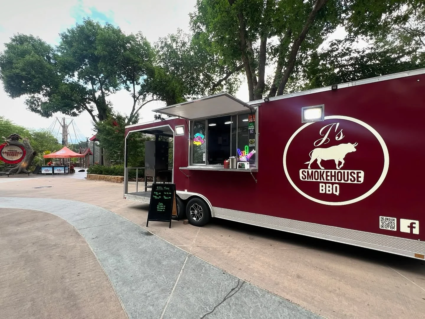 Food truck serving BBQ in a vibrant outdoor setting