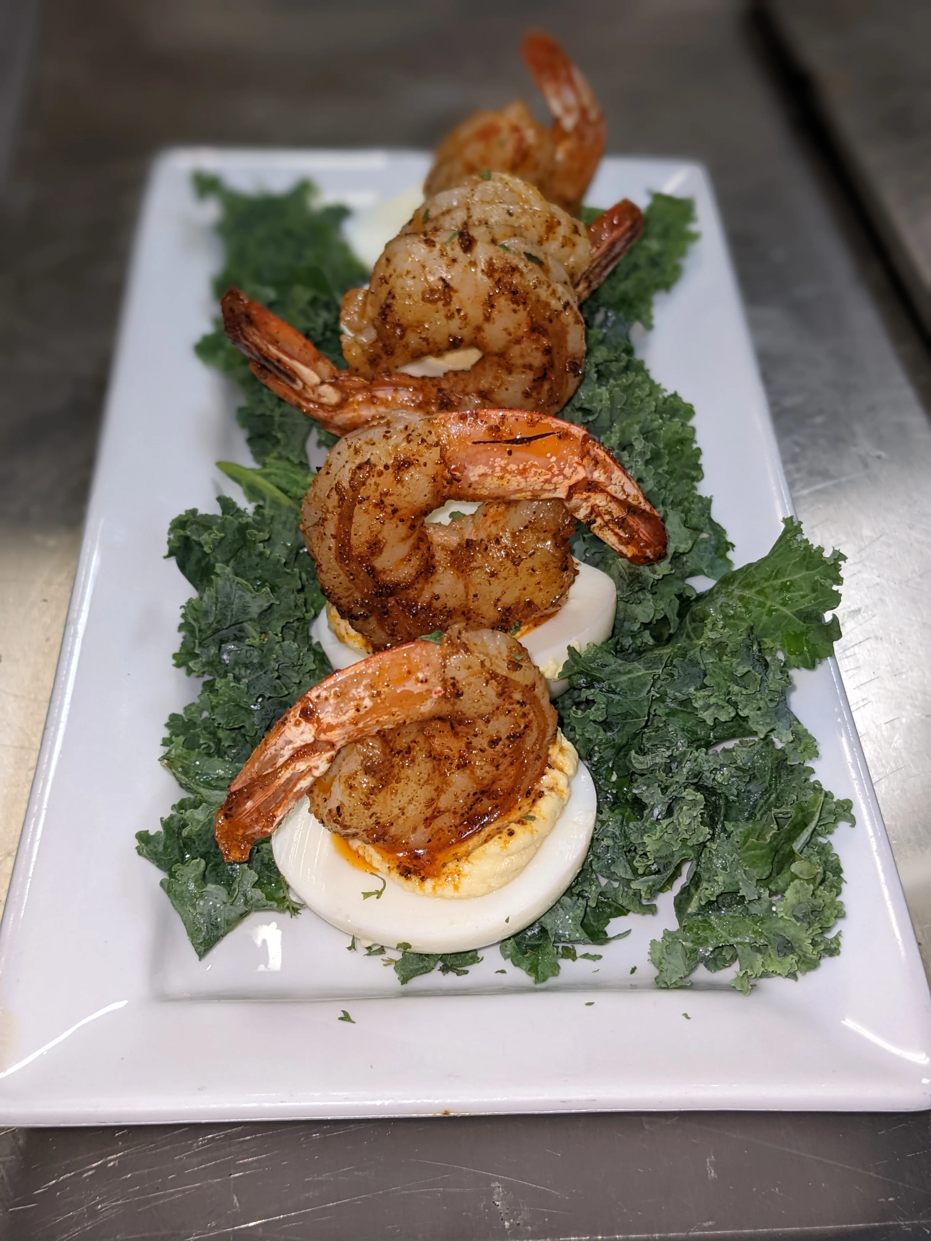 Southern-style shrimp and grits served on a bed of kale