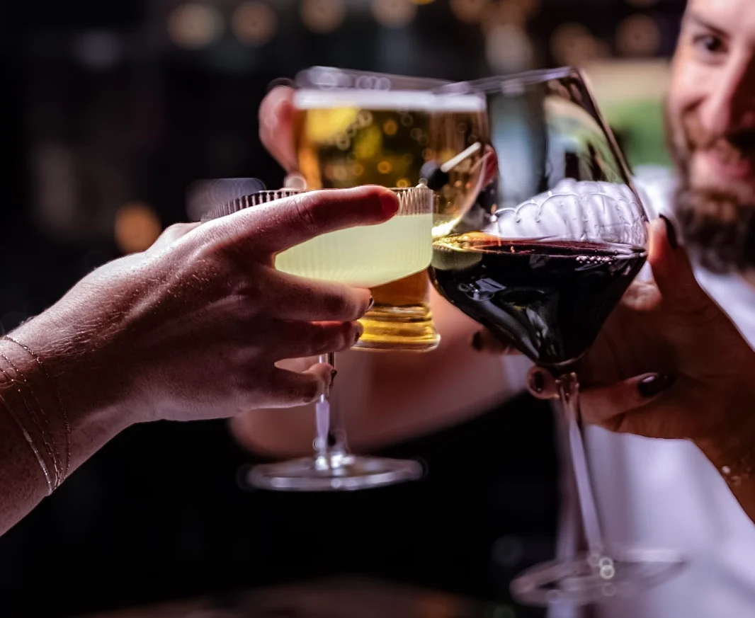 Cheers with drinks at a cozy restaurant table