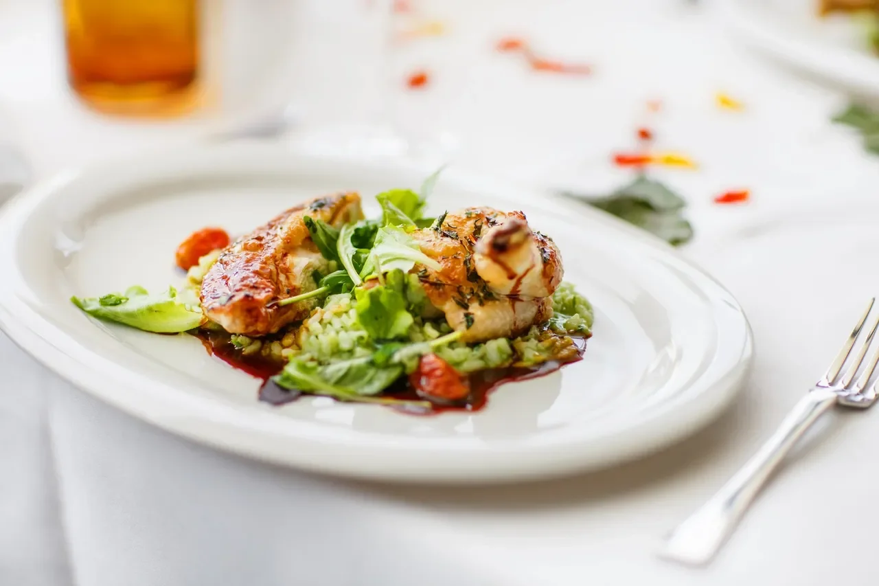 Grilled chicken with herb salad on a gourmet plate