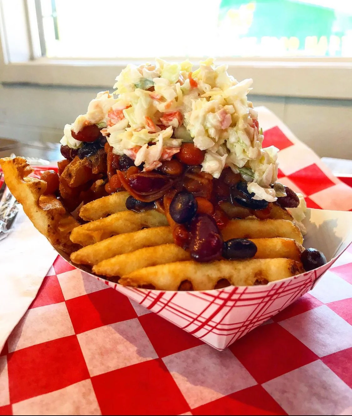 Delicious burger with toppings served on a wooden table