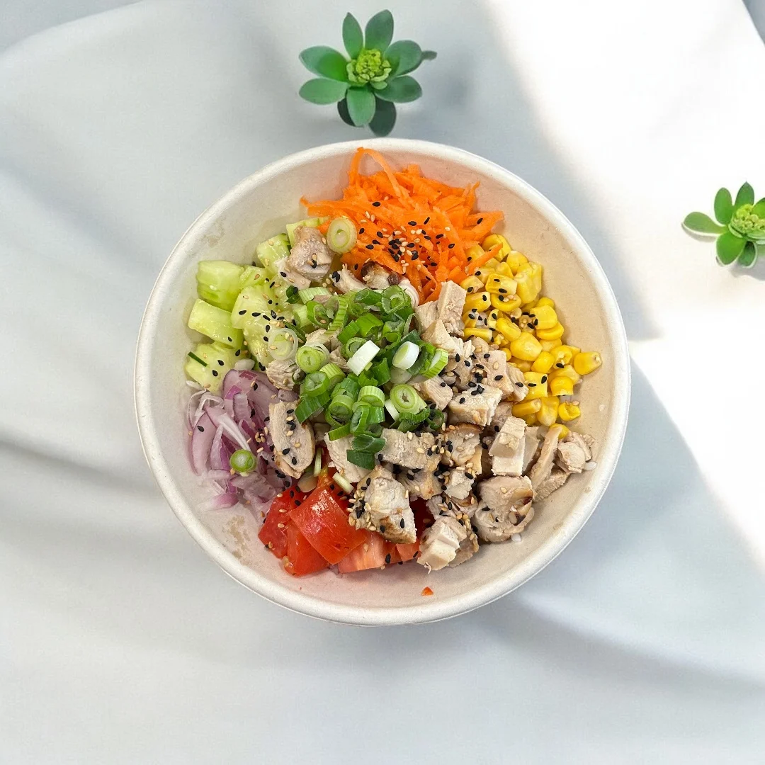 Colorful Asian chicken salad bowl with fresh vegetables