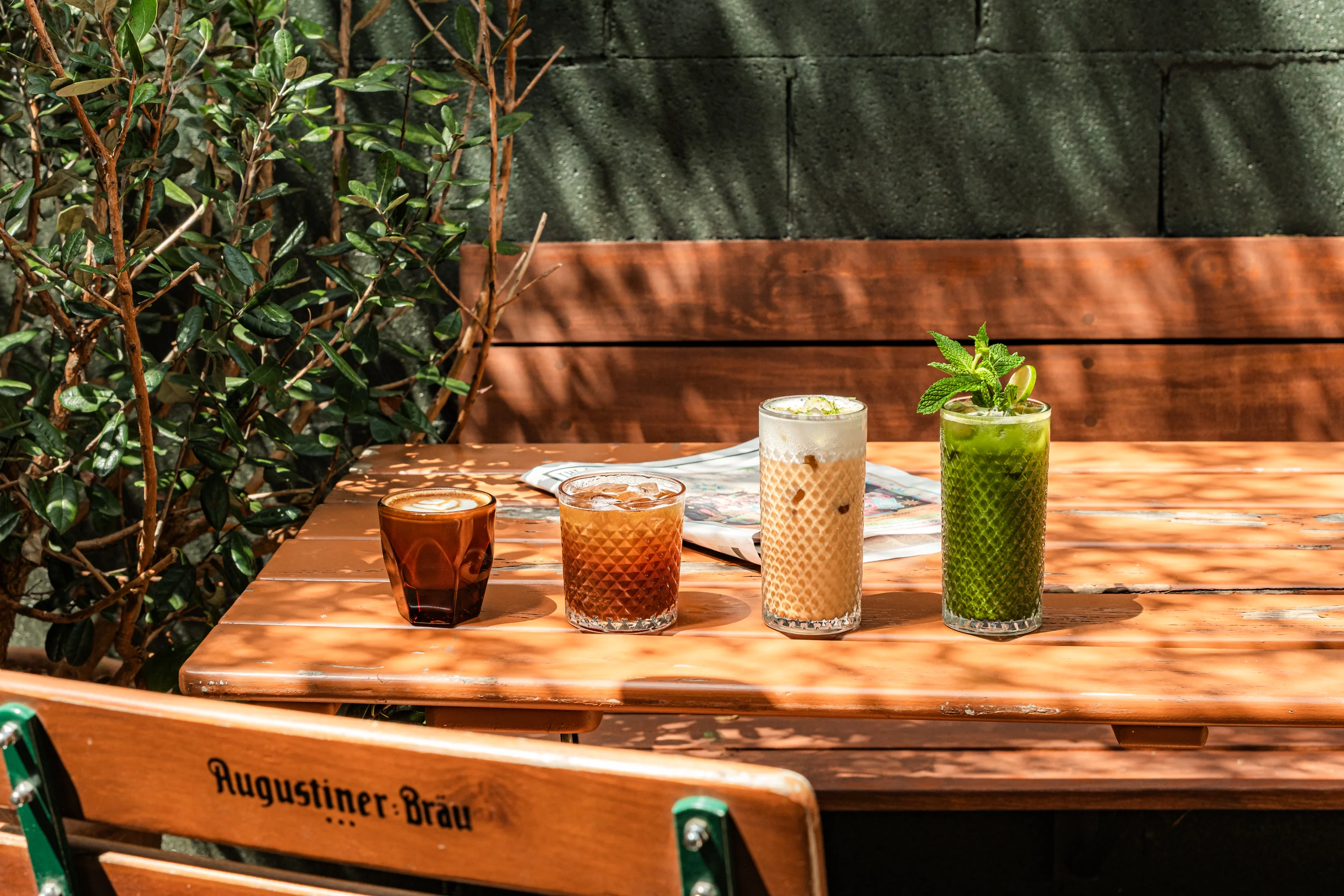 Refreshing drinks on a wooden table in a cozy outdoor setting