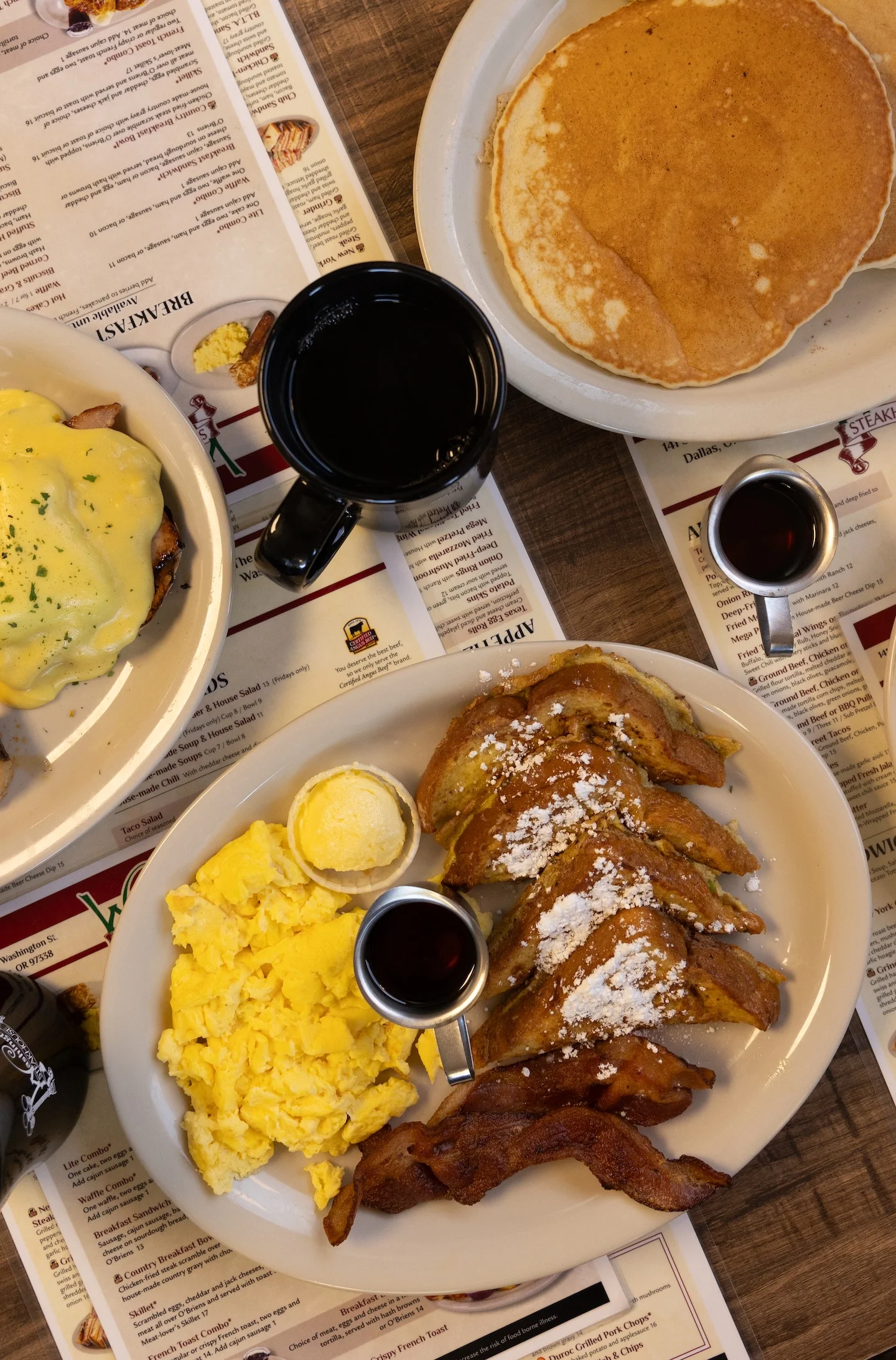 Classic American breakfast with French toast, scrambled eggs, and bacon