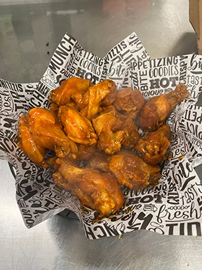 Crispy buffalo chicken wings served in a basket