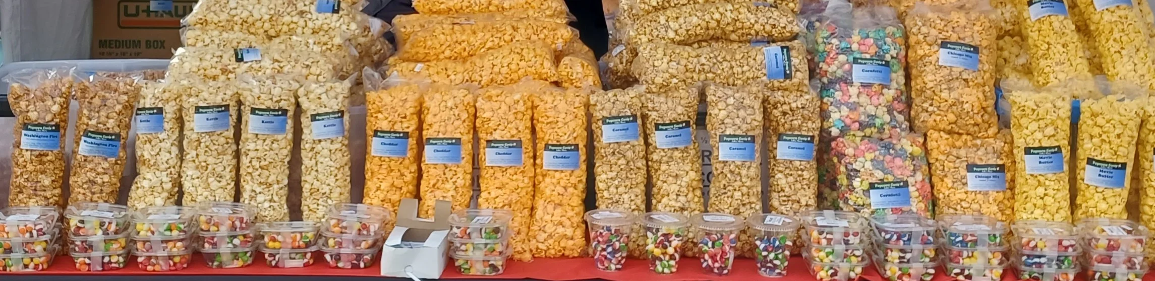 Colorful popcorn varieties at a snack stand