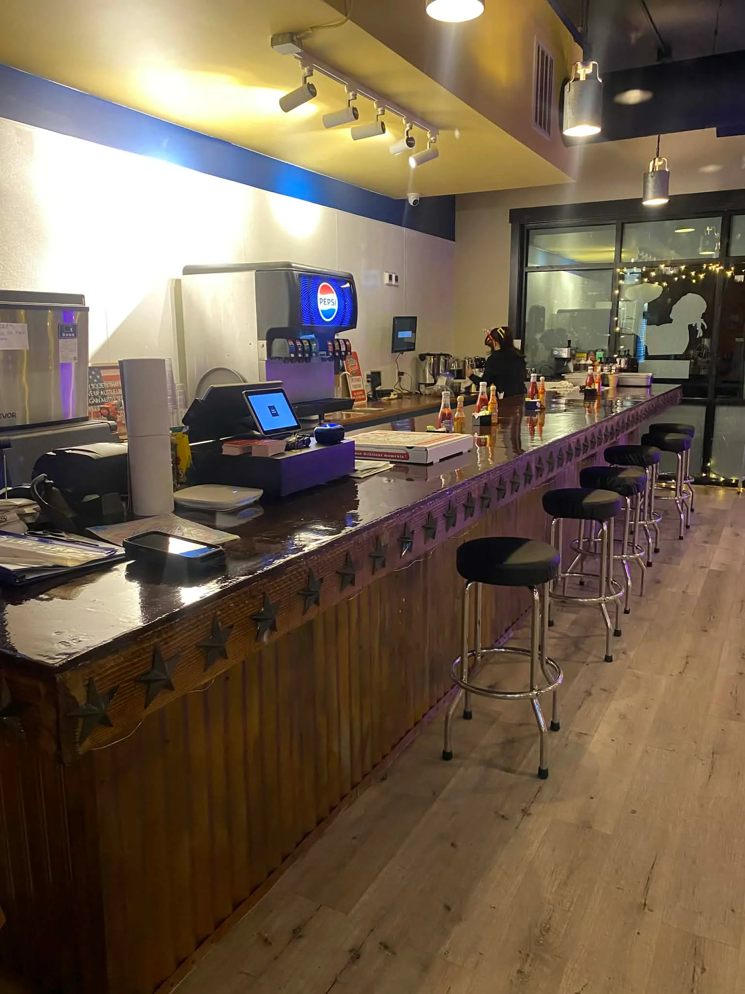 Modern bar counter with stools and beverage dispensers