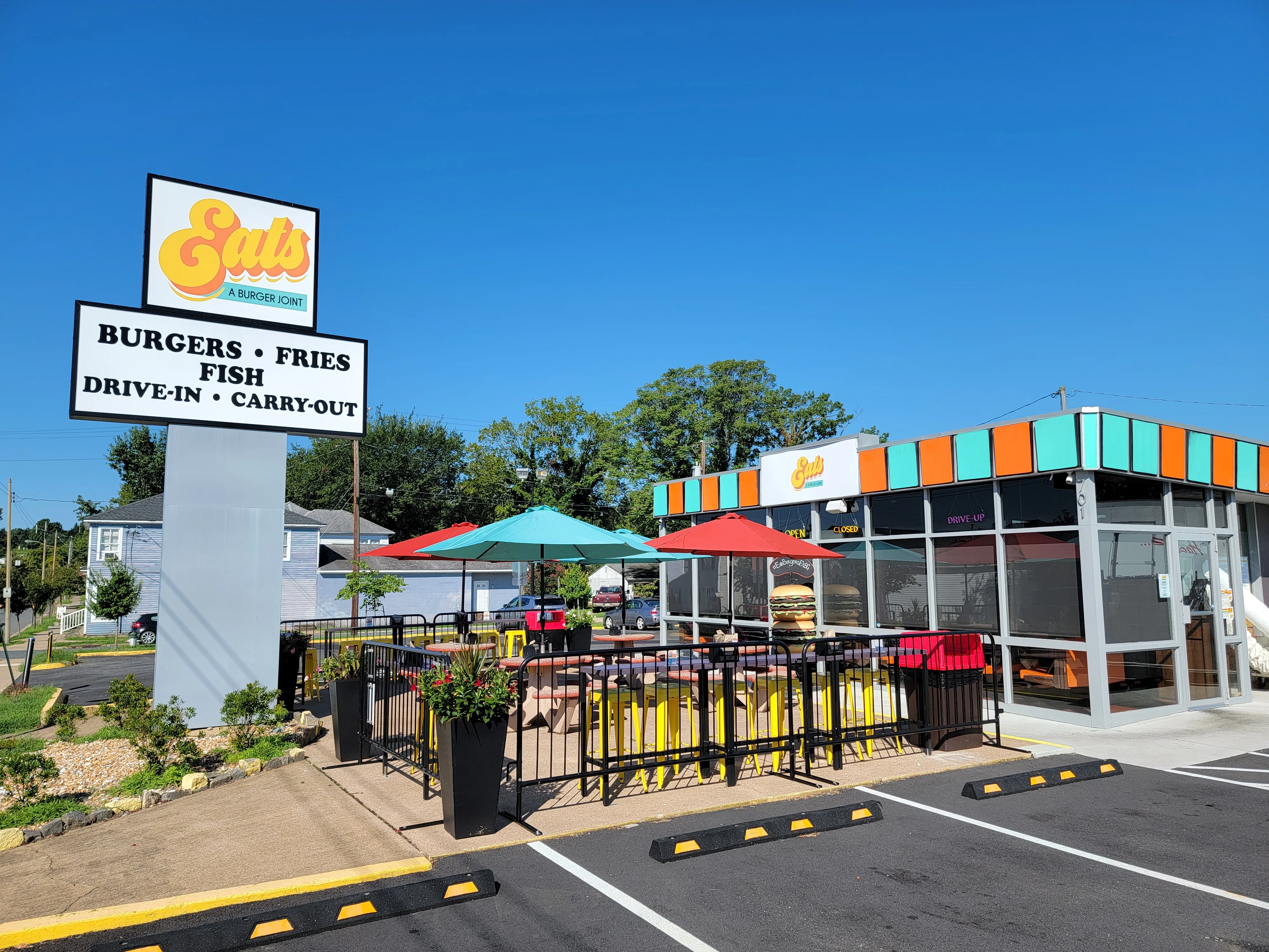 Colorful burger joint with outdoor seating and vibrant signage