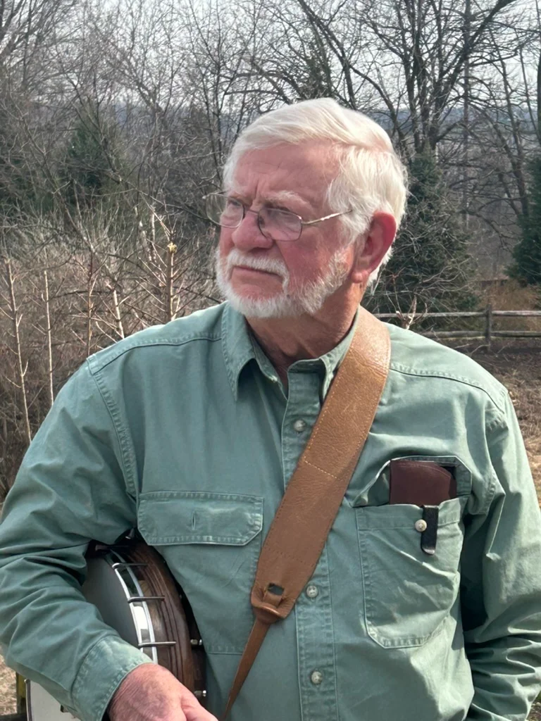 Man with a banjo in a natural setting