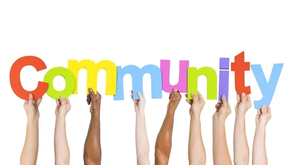 Diverse hands holding colorful letters spelling 'Community'