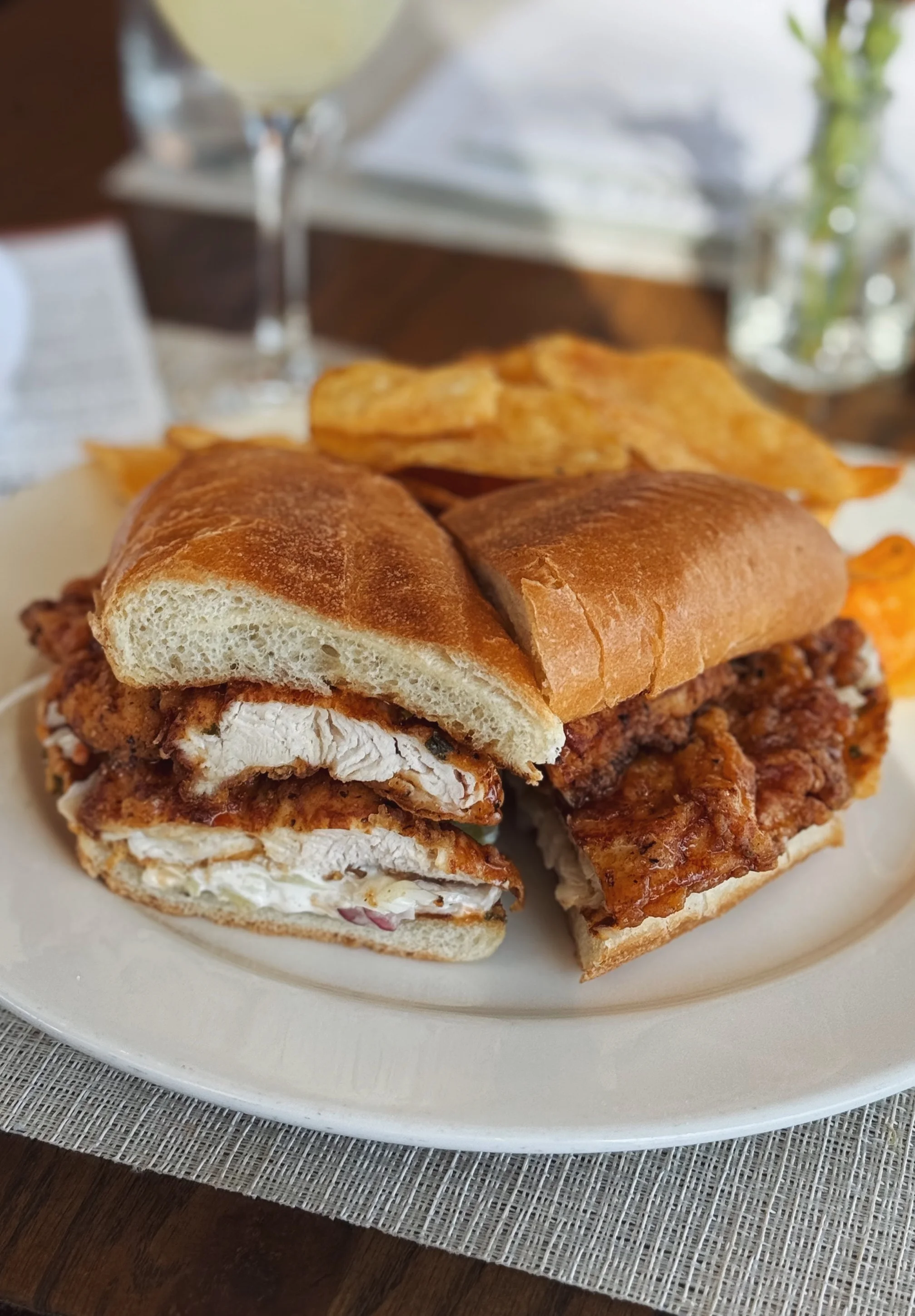 Crispy fried chicken sandwich with a refreshing cocktail
