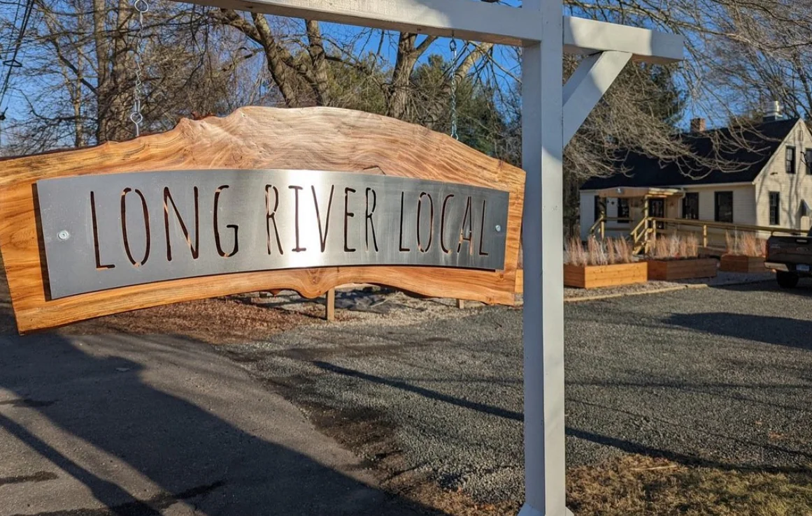 Sign for Long River Local restaurant with rustic wooden design