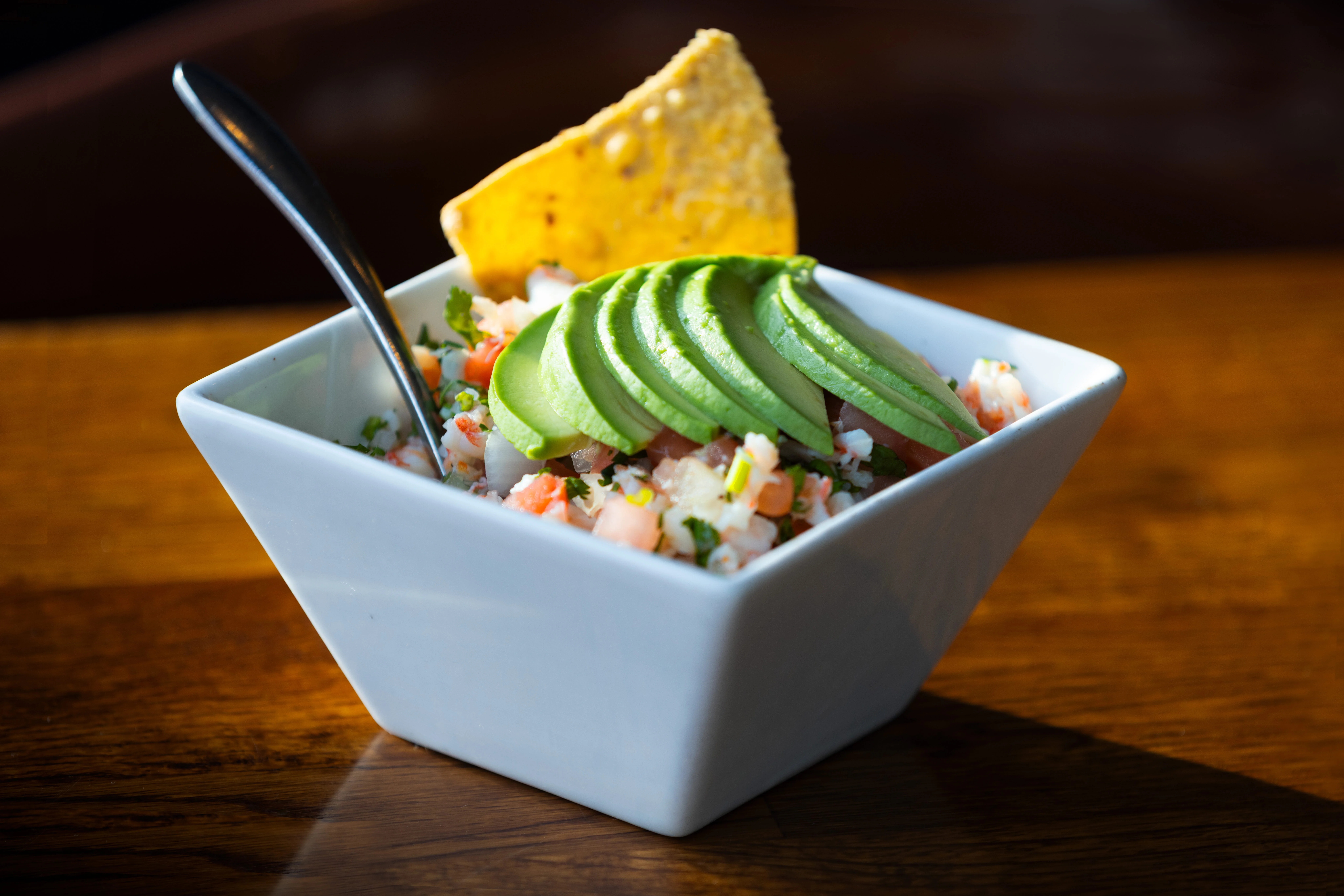 Fresh Mexican ceviche with avocado and tortilla chip