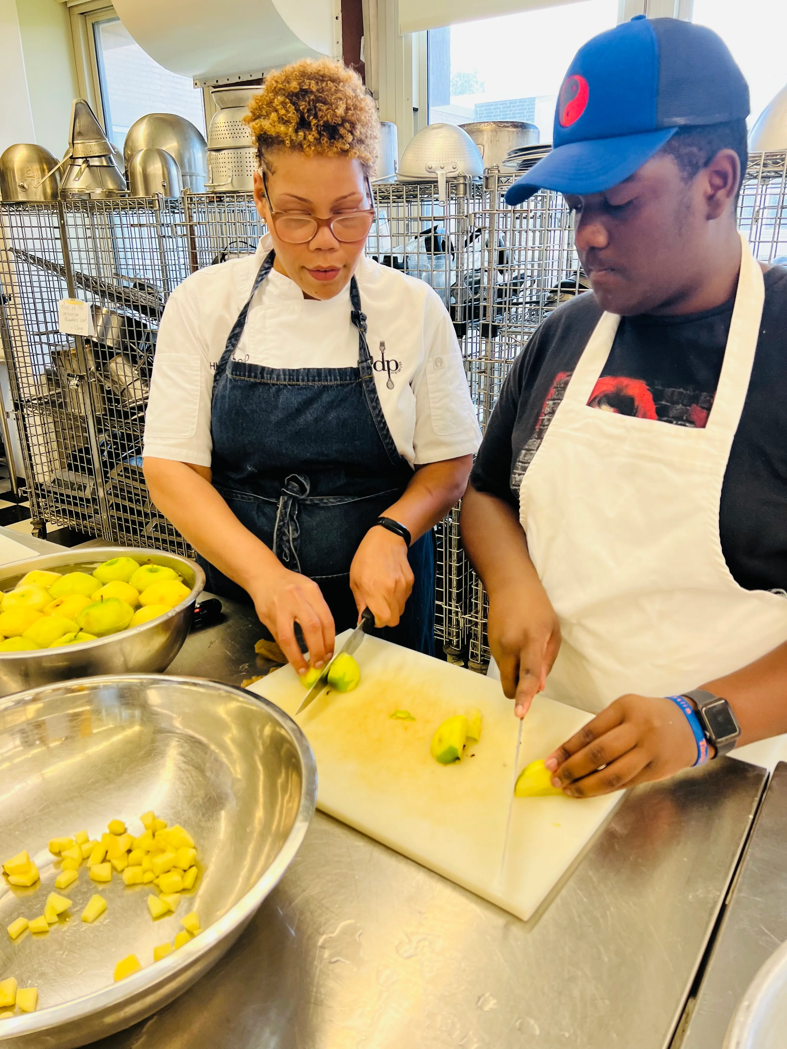 Culinary students preparing fresh ingredients in a professional kitchen