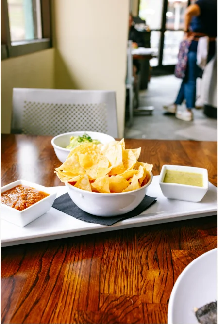 Crispy tortilla chips with guacamole and salsa