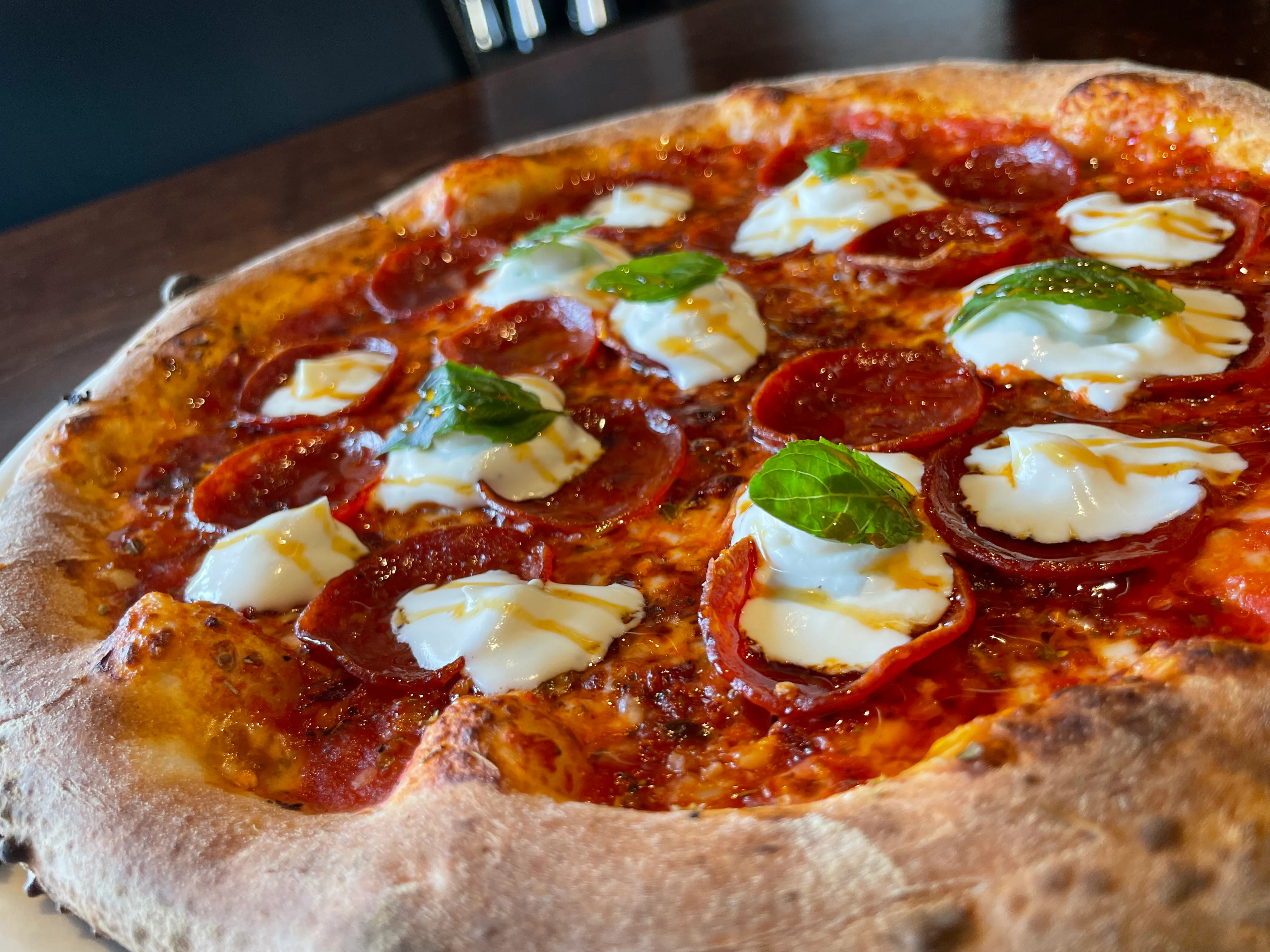 Pepperoni pizza with fresh mozzarella and basil
