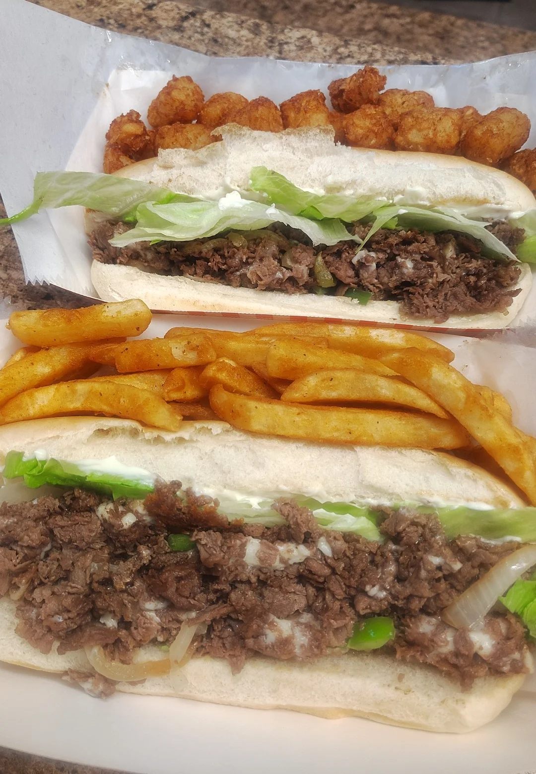 Philly cheesesteak sandwich with crispy fries