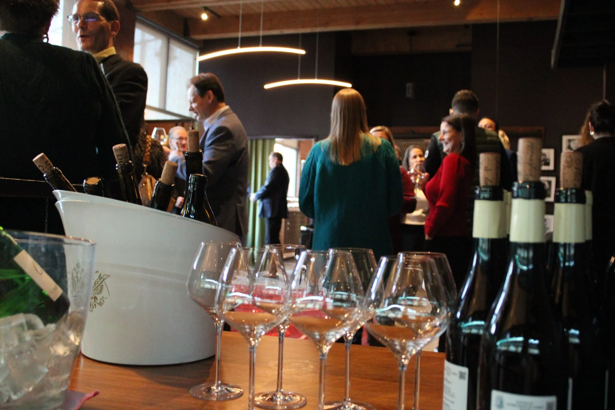 Elegant gathering with wine glasses and bottles in a modern restaurant setting