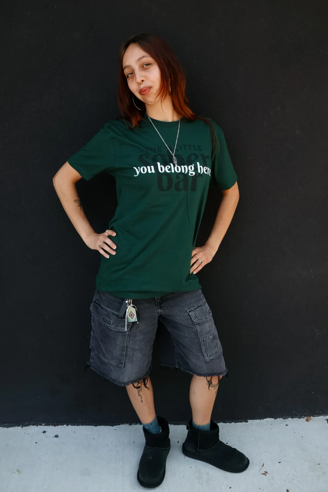 Portrait of restaurant staff member wearing branded bar shirt