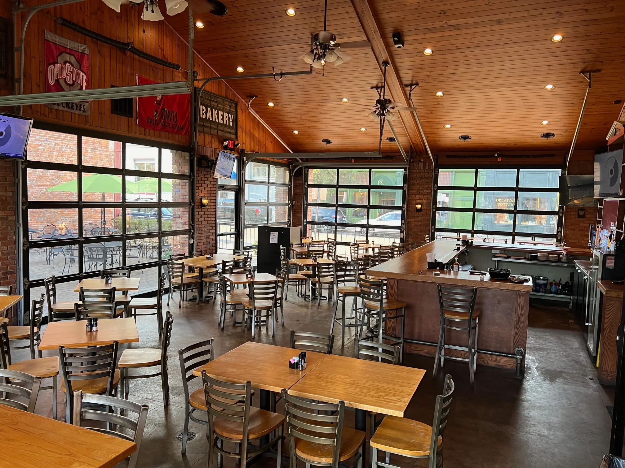 Cozy restaurant interior with wooden accents and large windows