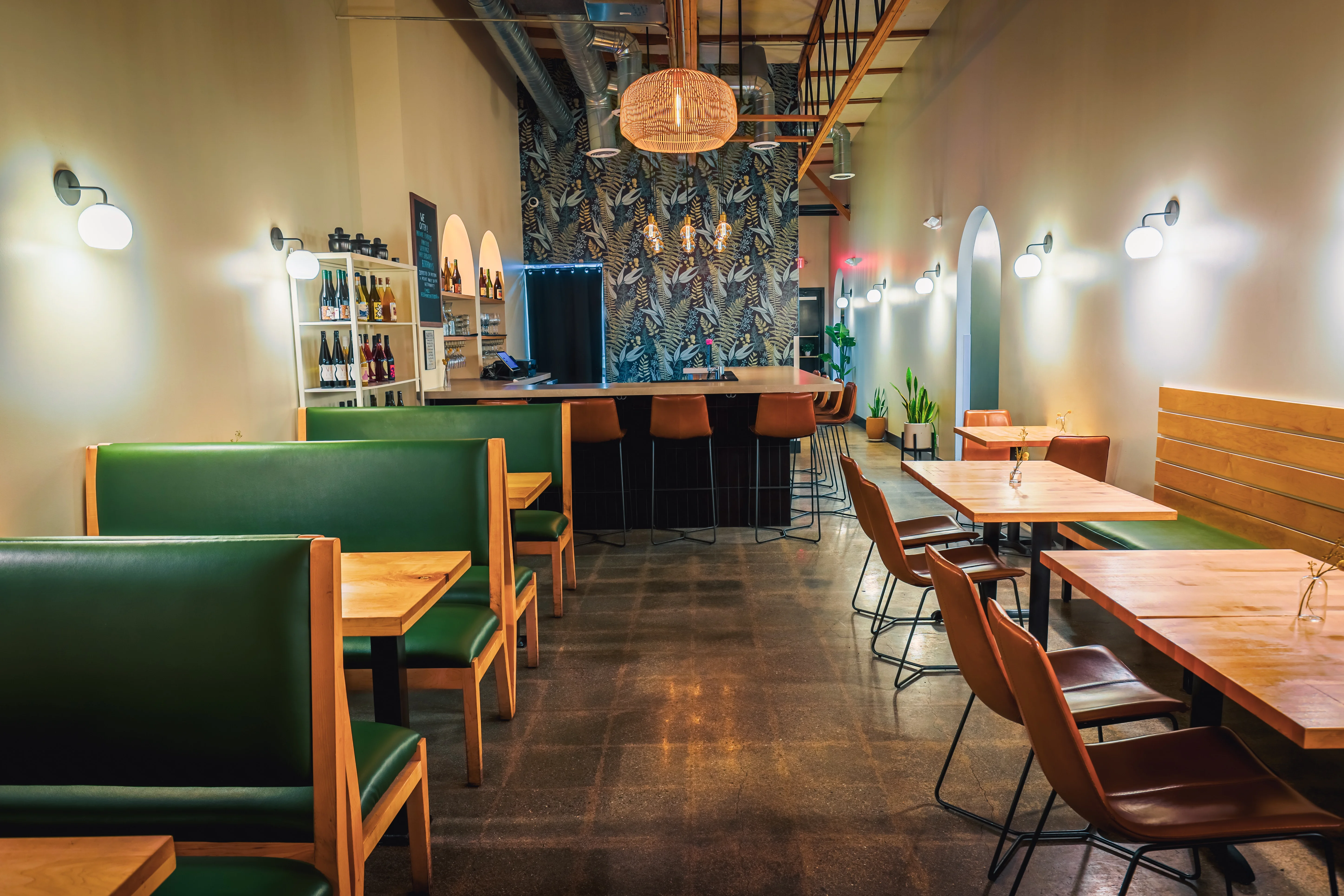 Modern restaurant interior with green booths and stylish decor
