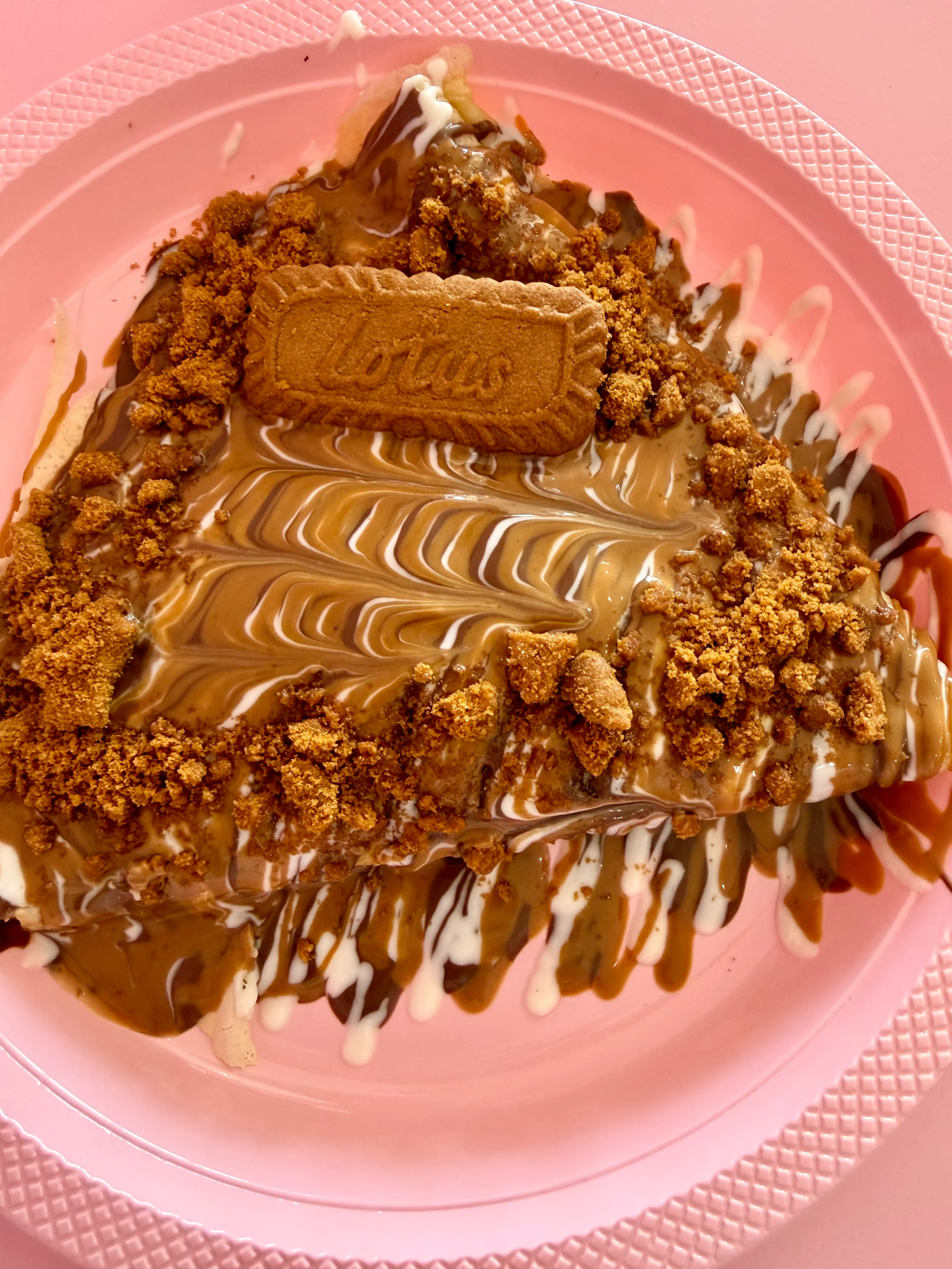 Delicious dessert topped with caramel, cookie crumbles, and a Lotus biscuit.