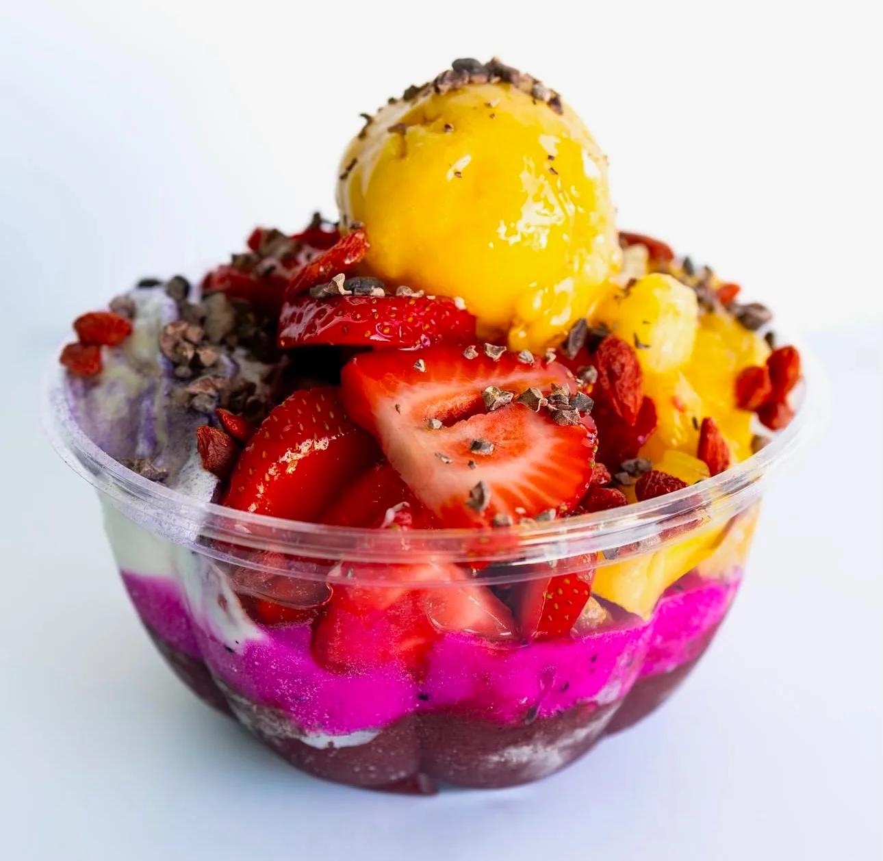 Colorful acai bowl topped with fresh fruits and sorbet