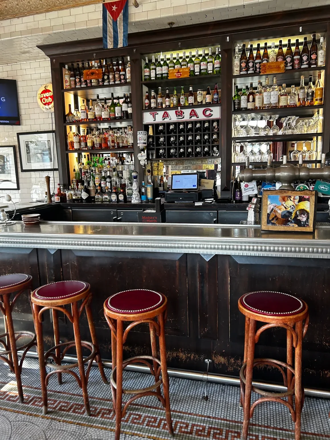 Stylish bar counter with a variety of spirits and Cuban decor