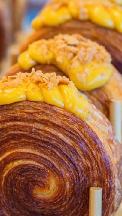Delicious cronut with mango cream topping