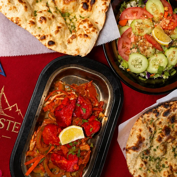 Nepalese chicken curry with naan and fresh salad