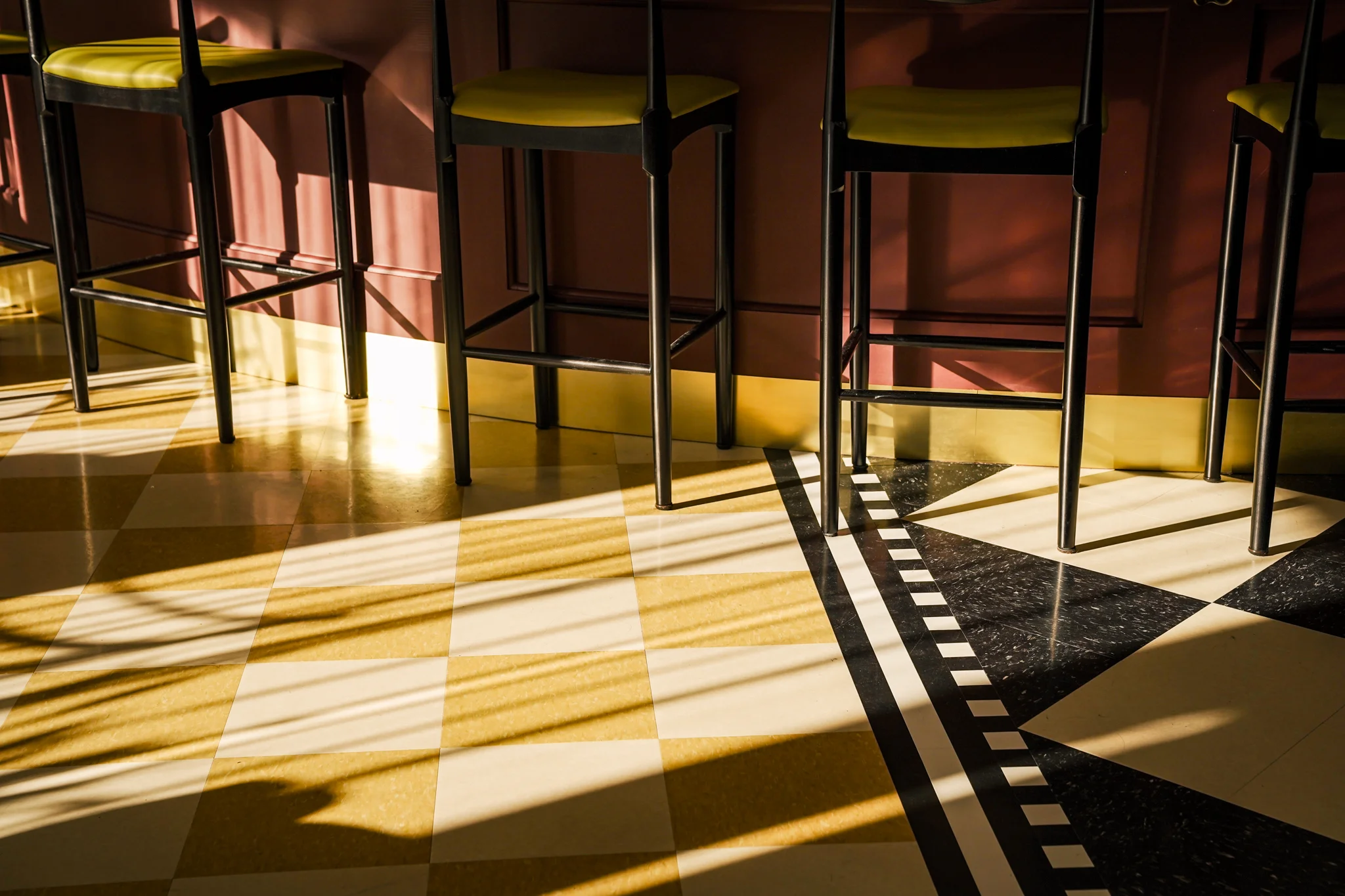 Stylish restaurant bar area with modern stools and patterned flooring