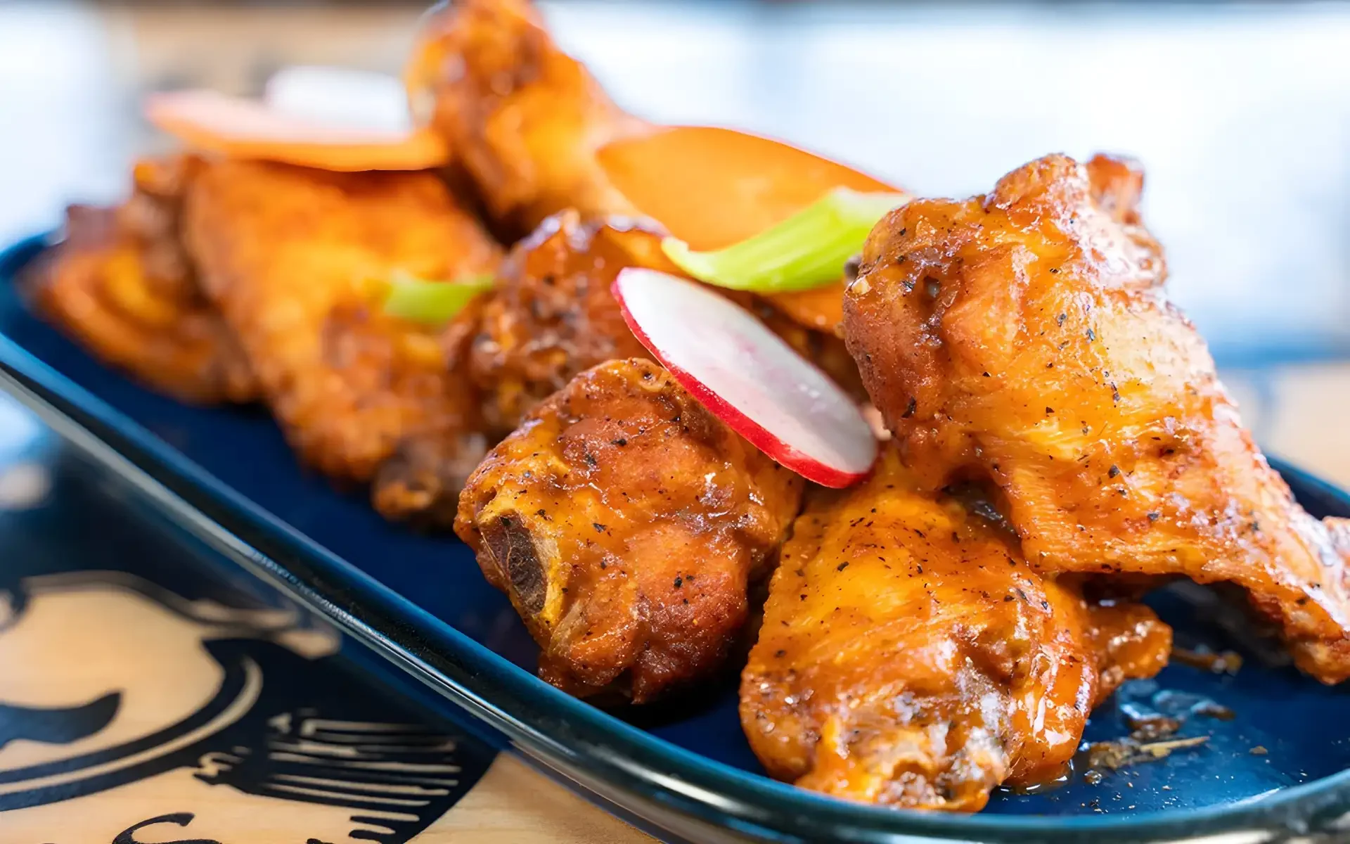 Crispy buffalo chicken wings served with fresh vegetables