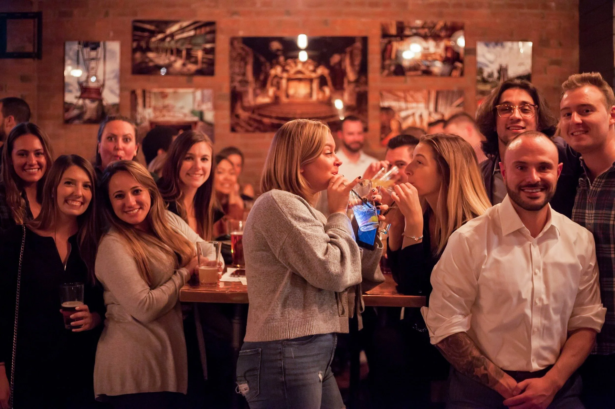 Group of friends enjoying drinks at a lively bar