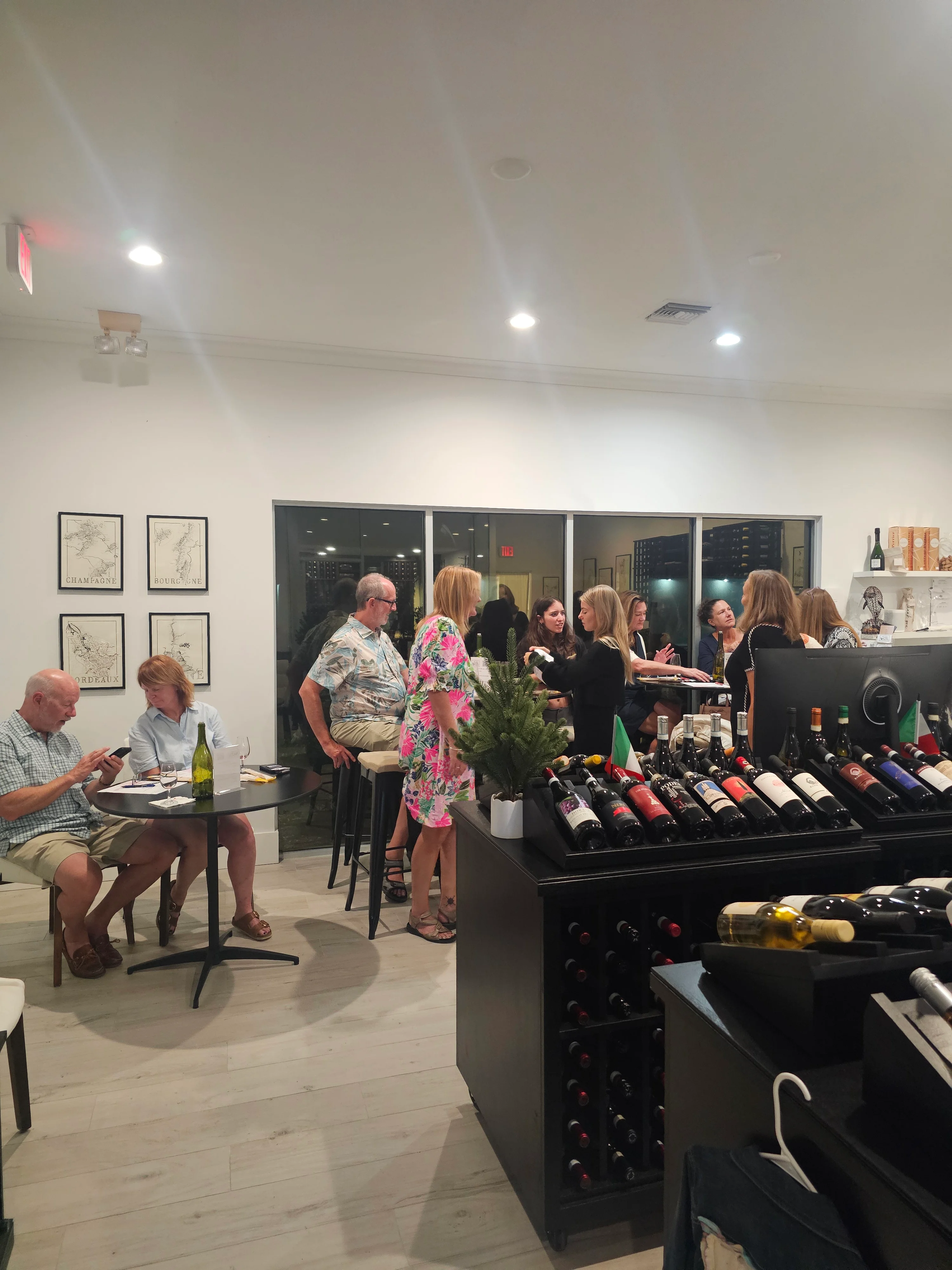 Cozy restaurant interior with guests enjoying wine and conversation.