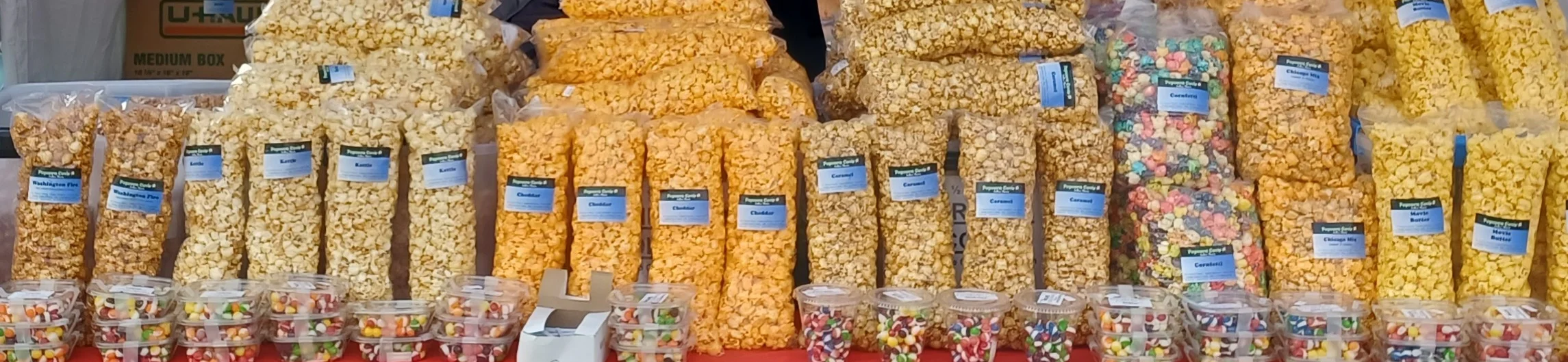 Colorful popcorn varieties at a snack stand