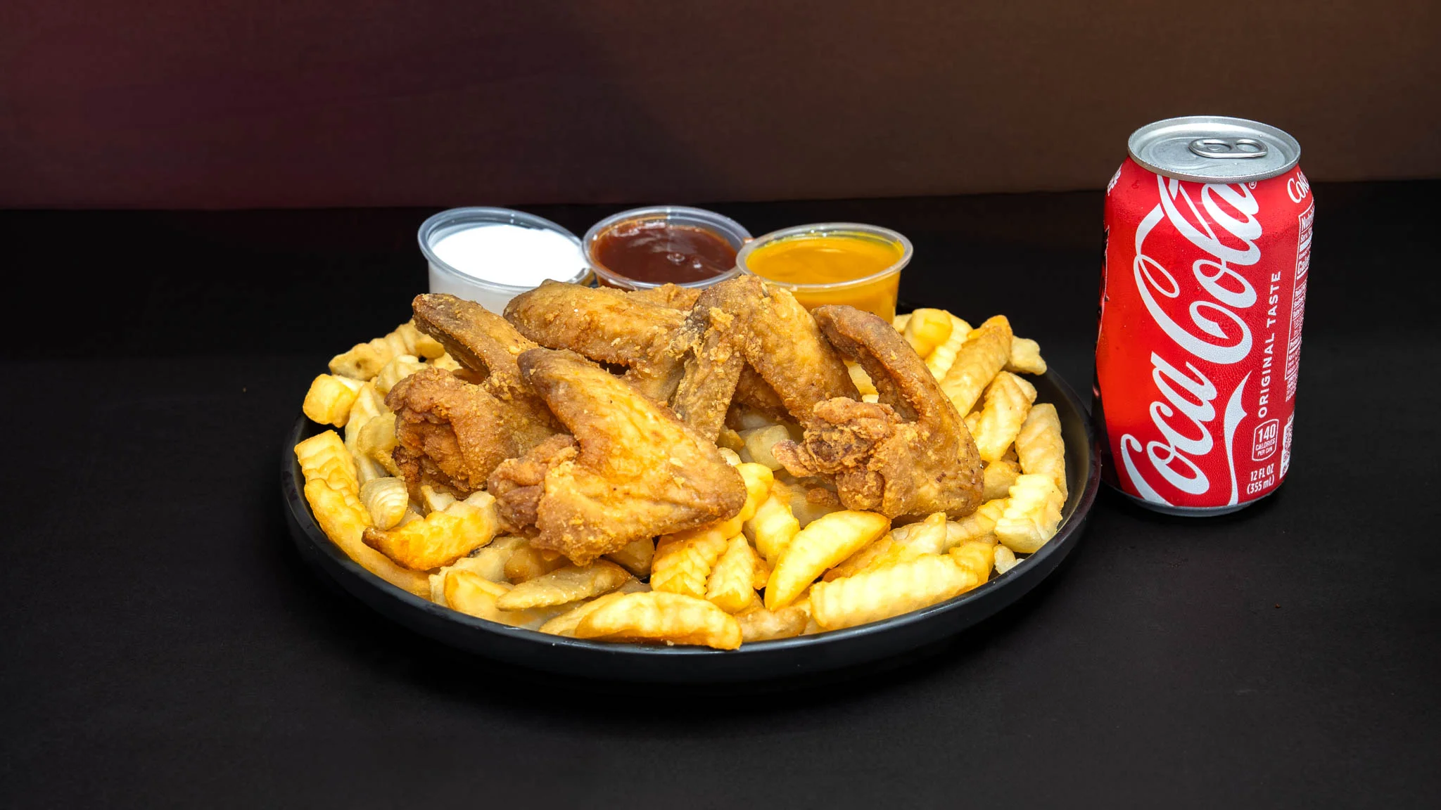 Crispy fried chicken wings with crinkle-cut fries