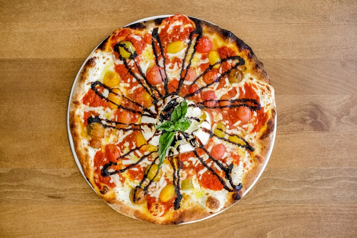 Artisan Margherita pizza with colorful tomatoes and balsamic drizzle