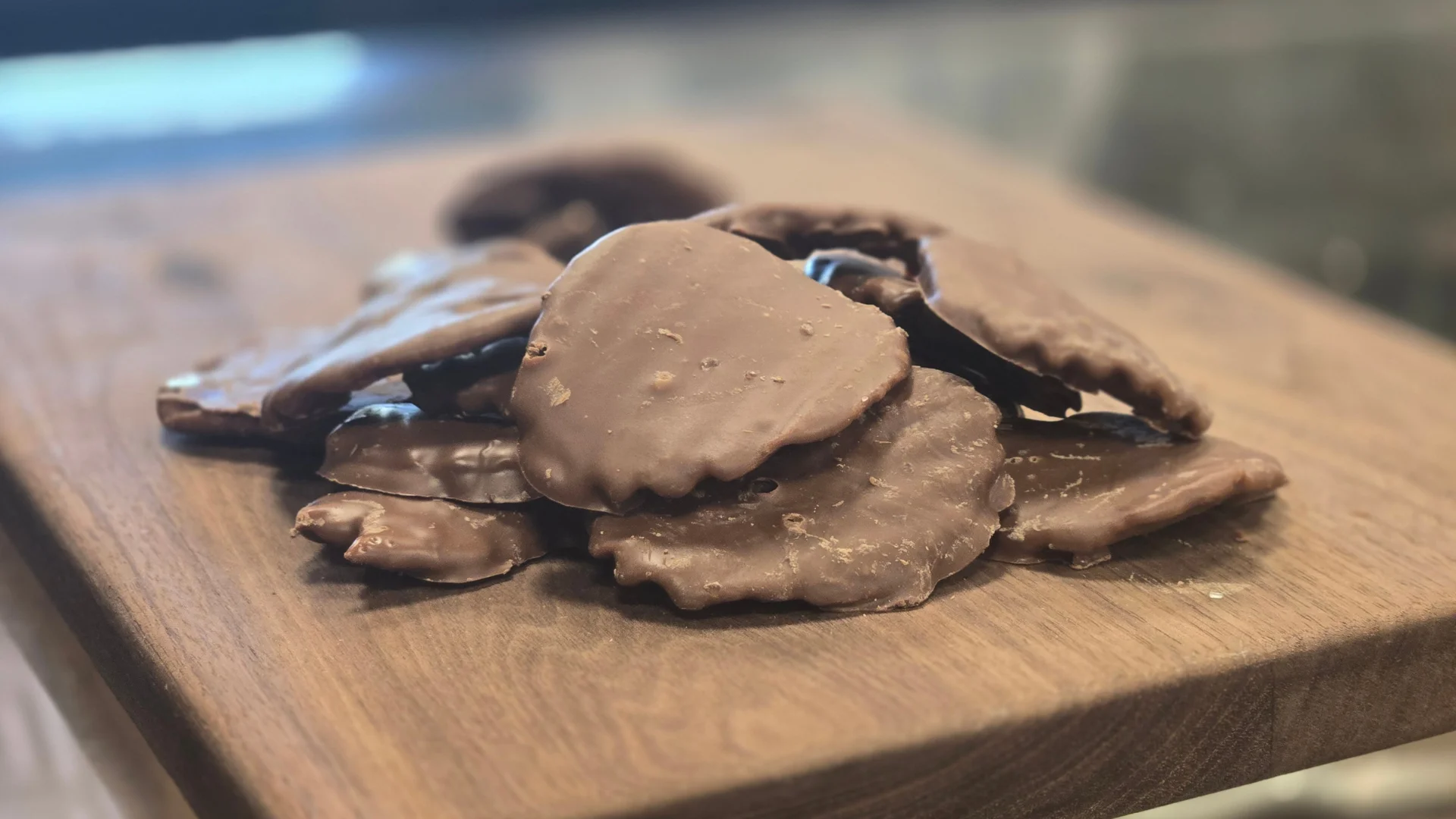 Chocolate-covered peppermint patties on a wooden board
