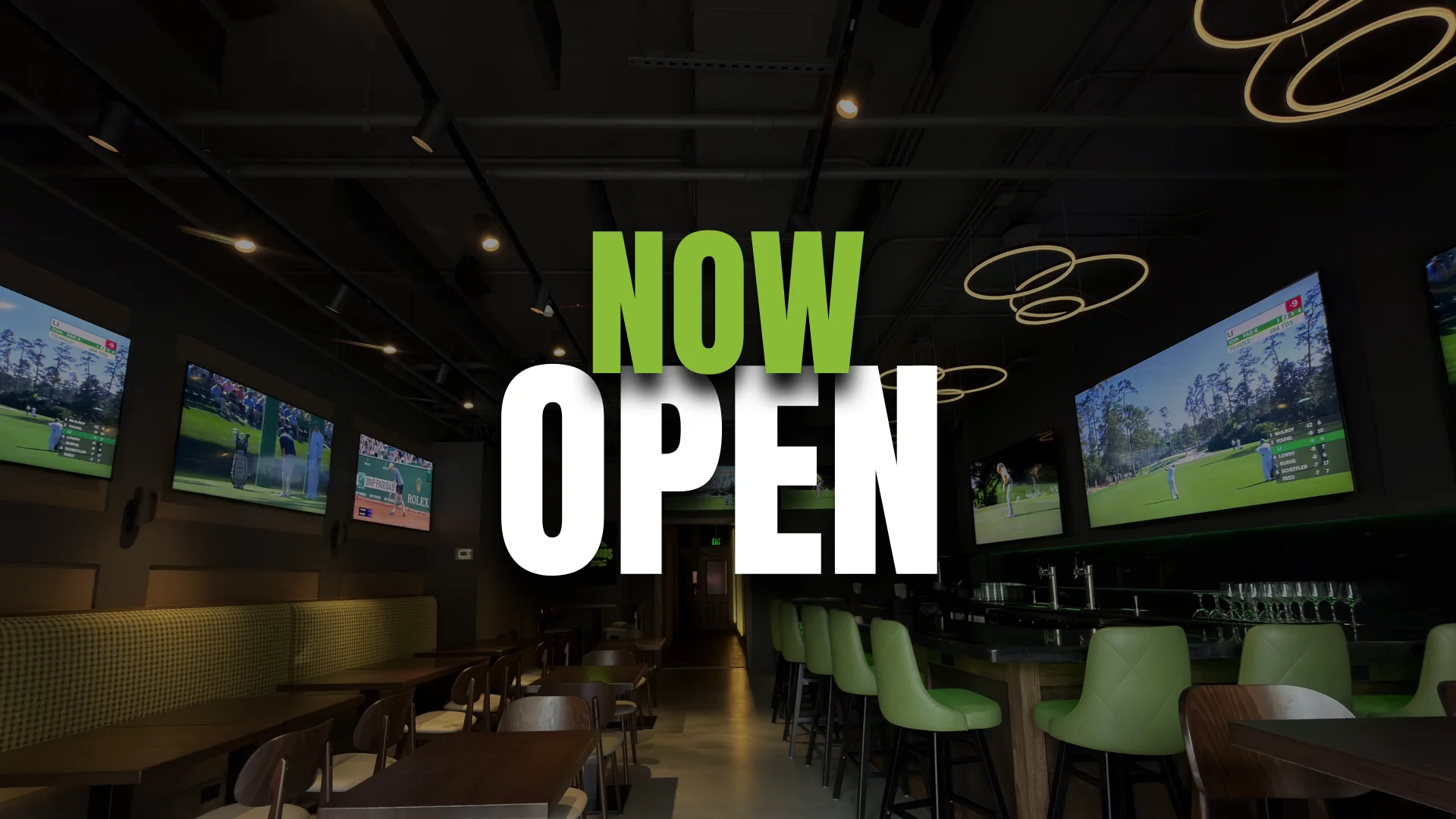 Interior of a restaurant with TVs showing sports, announcing 'Now Open'.