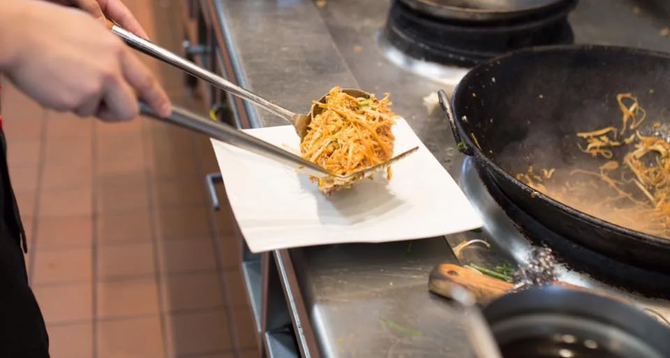 A restaurant chef preparing a dish