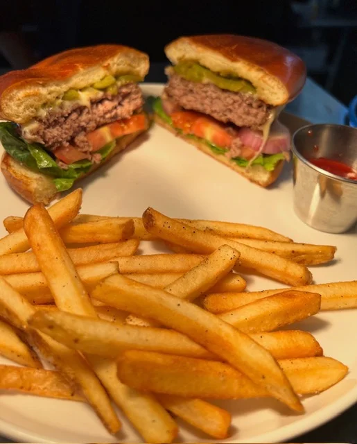 Juicy American cheeseburger with fries