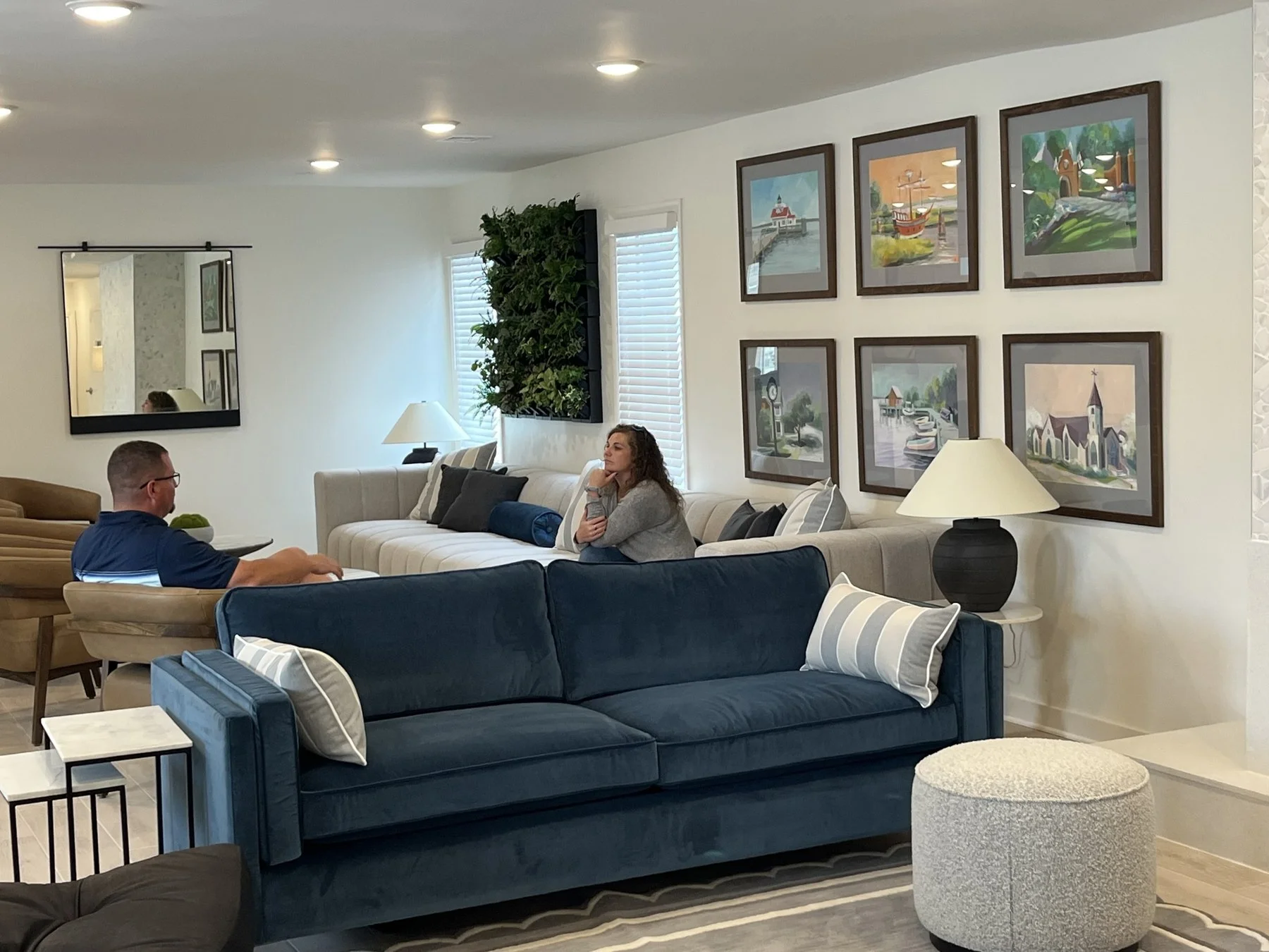 Lobby lounge at Hotel Manteo with blue sofas and Outer Banks artwork
