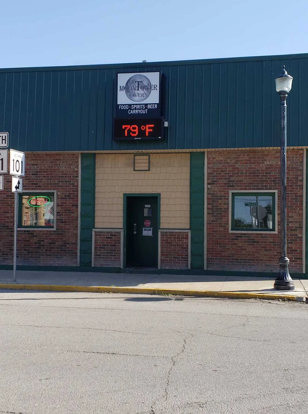 Exterior view of Moon Tower Tavern with signage and temperature display