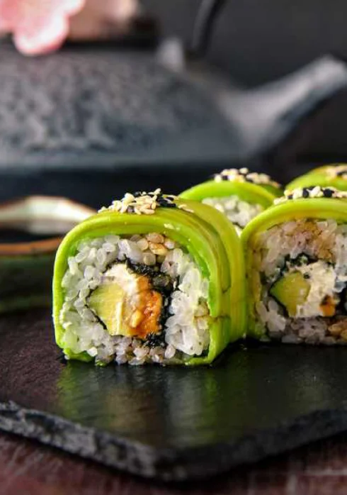 Vibrant Japanese sushi rolls with avocado and sesame seeds