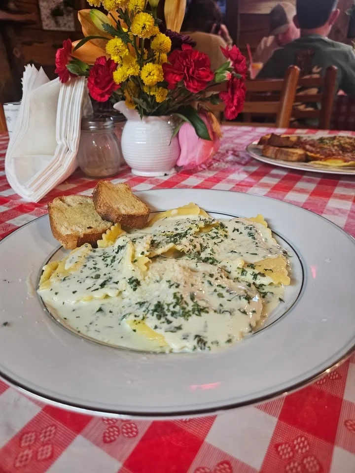 Creamy ravioli served with garlic bread in a cozy restaurant setting