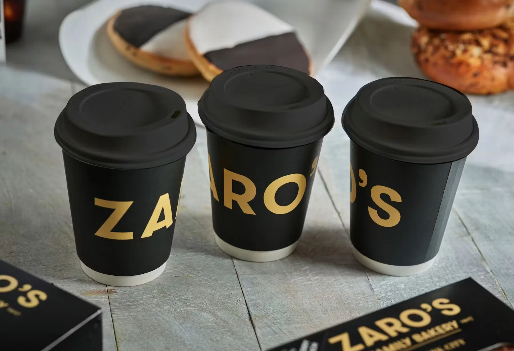 Coffee cups from Zaro's Bakery on a rustic table