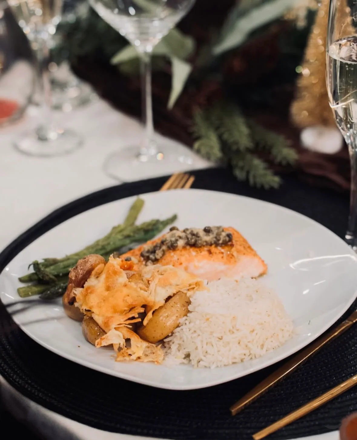 Baked salmon with rice and asparagus on a festive dining table
