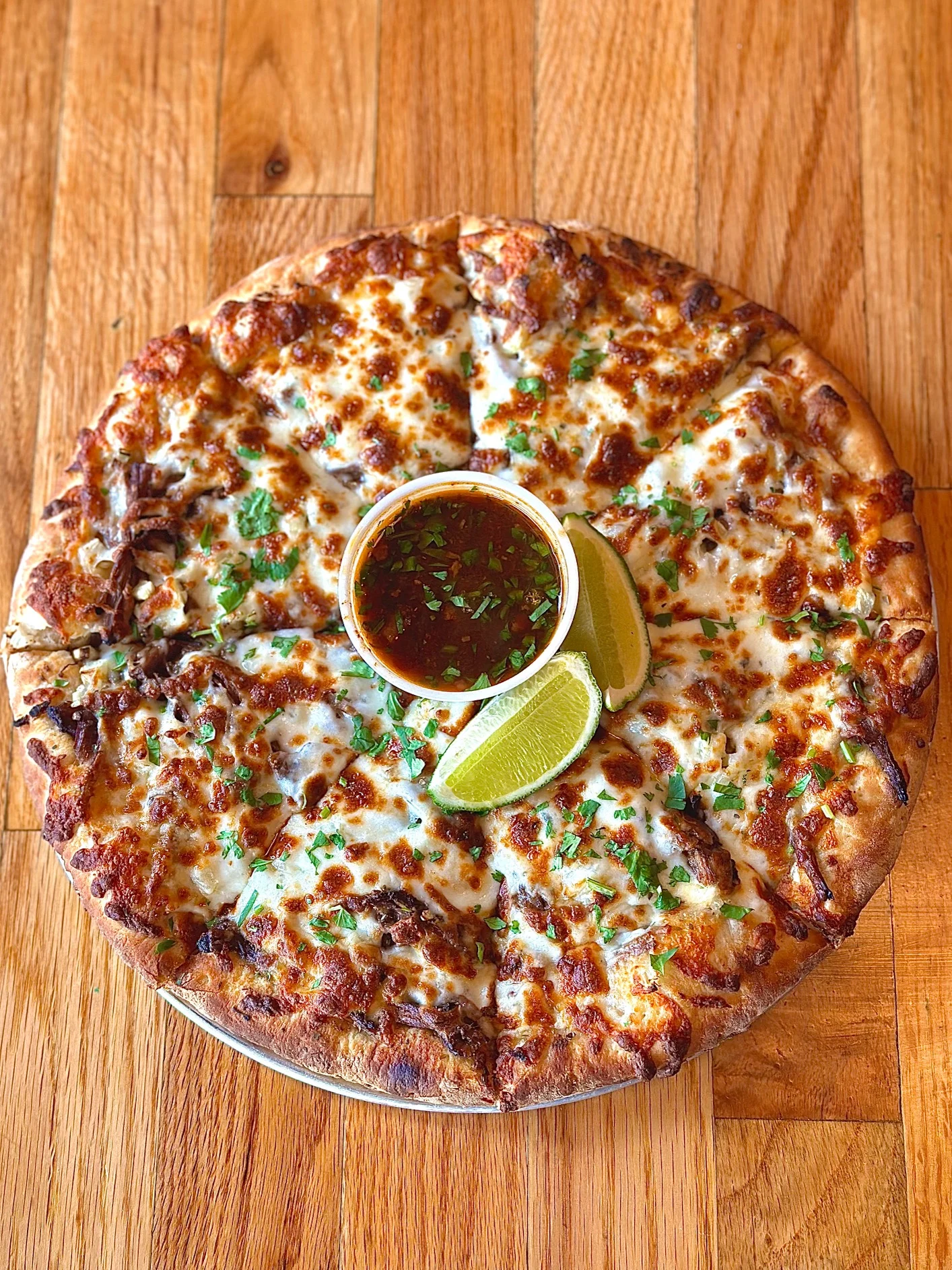 Delicious Mexican-style pizza with beef and dipping sauce